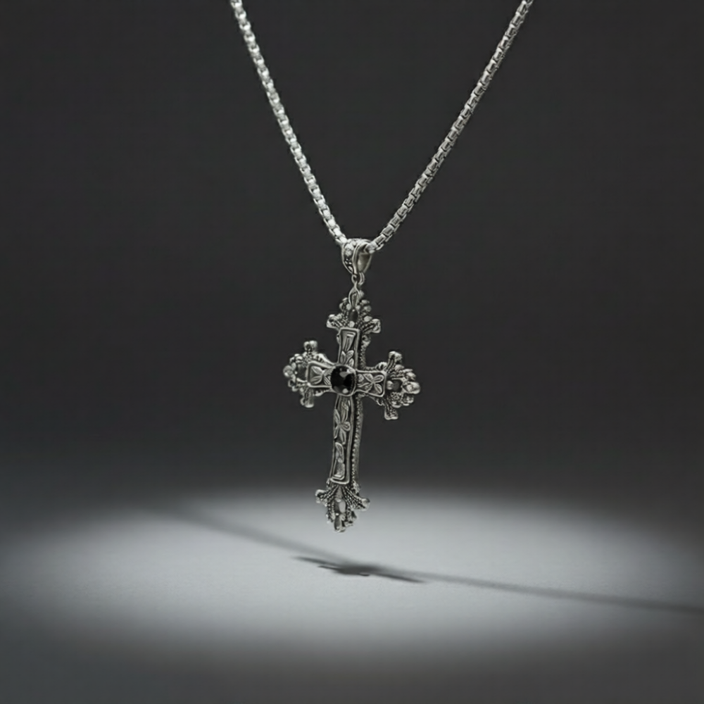 Silver cross pendant necklace on a dark background