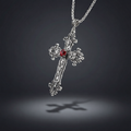 Silver cross pendant with a red gemstone on a dark background