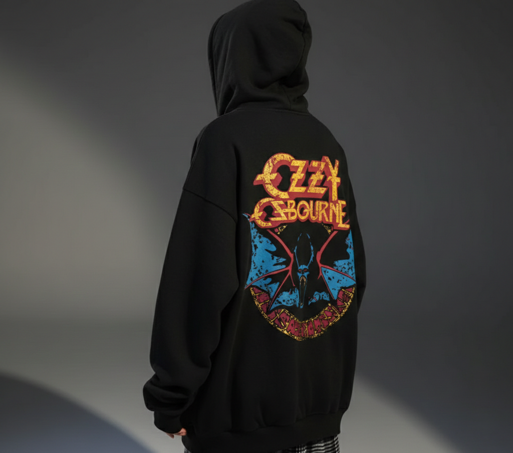 Person wearing a black hoodie with Ozzy Osbourne logo on the back against a gray background